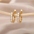 Złote kolczyki sztyfty z cyrkoniami — geometryczne i eleganckie